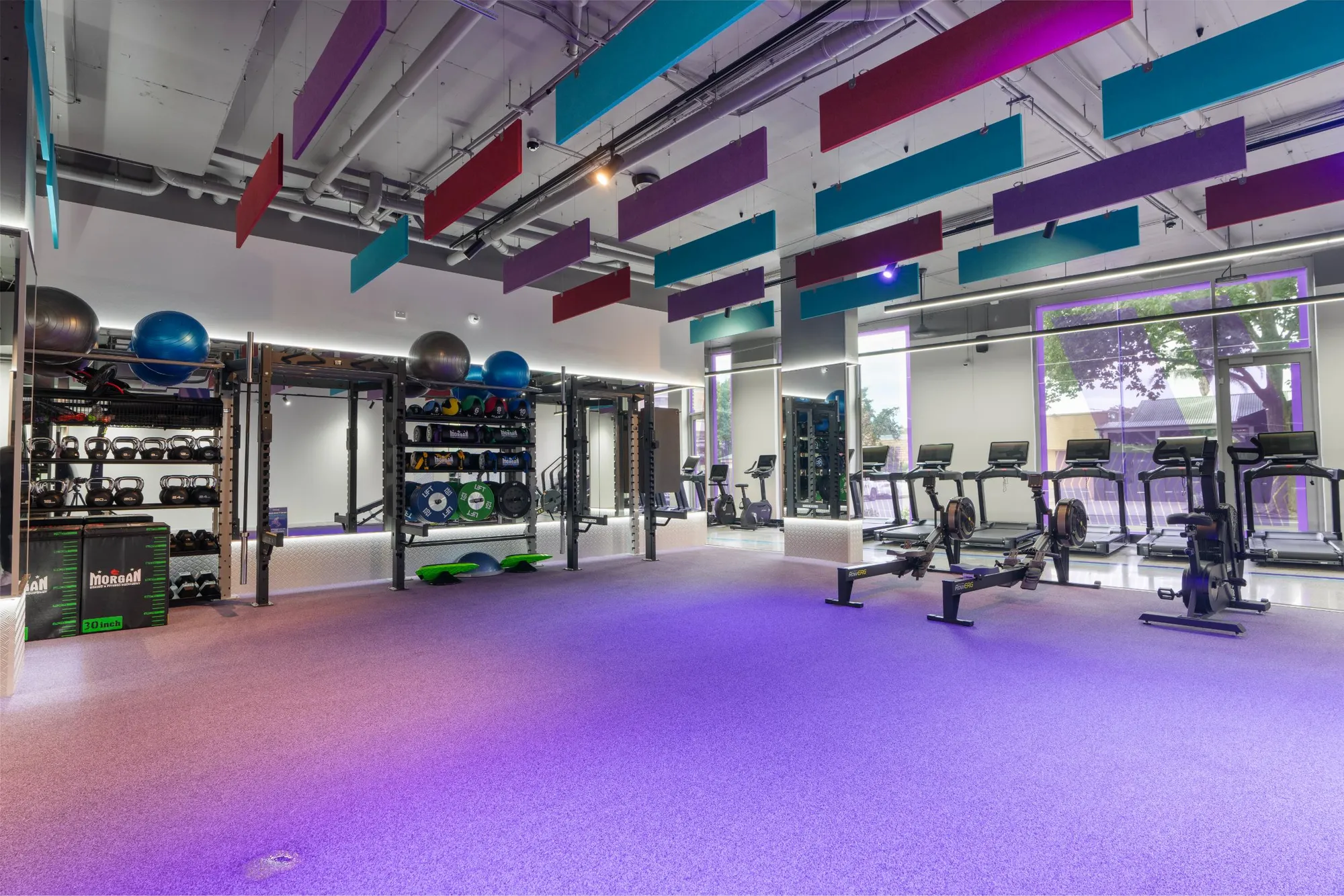 A functional zone with rowers and a violet floor at a Maddimax club.