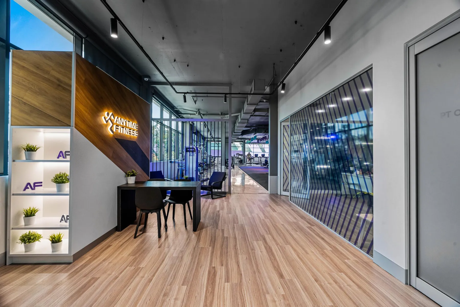 The premium reception at a Maddimax club, with timber detailing and branded signage.