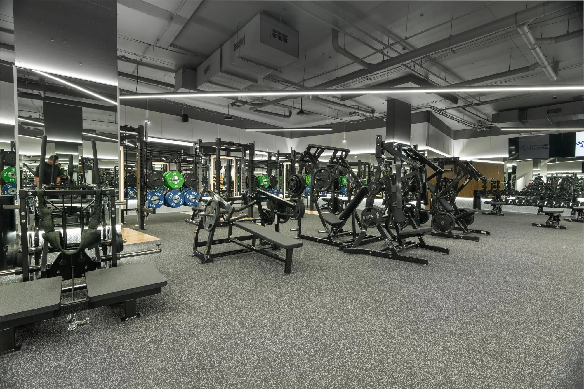 A dark, equipment-filled strength floor at a Maddimax club.